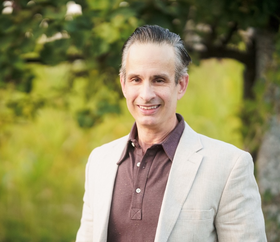 Phillip Dennis, founder of Stanzary, outdoors in a cream blazer